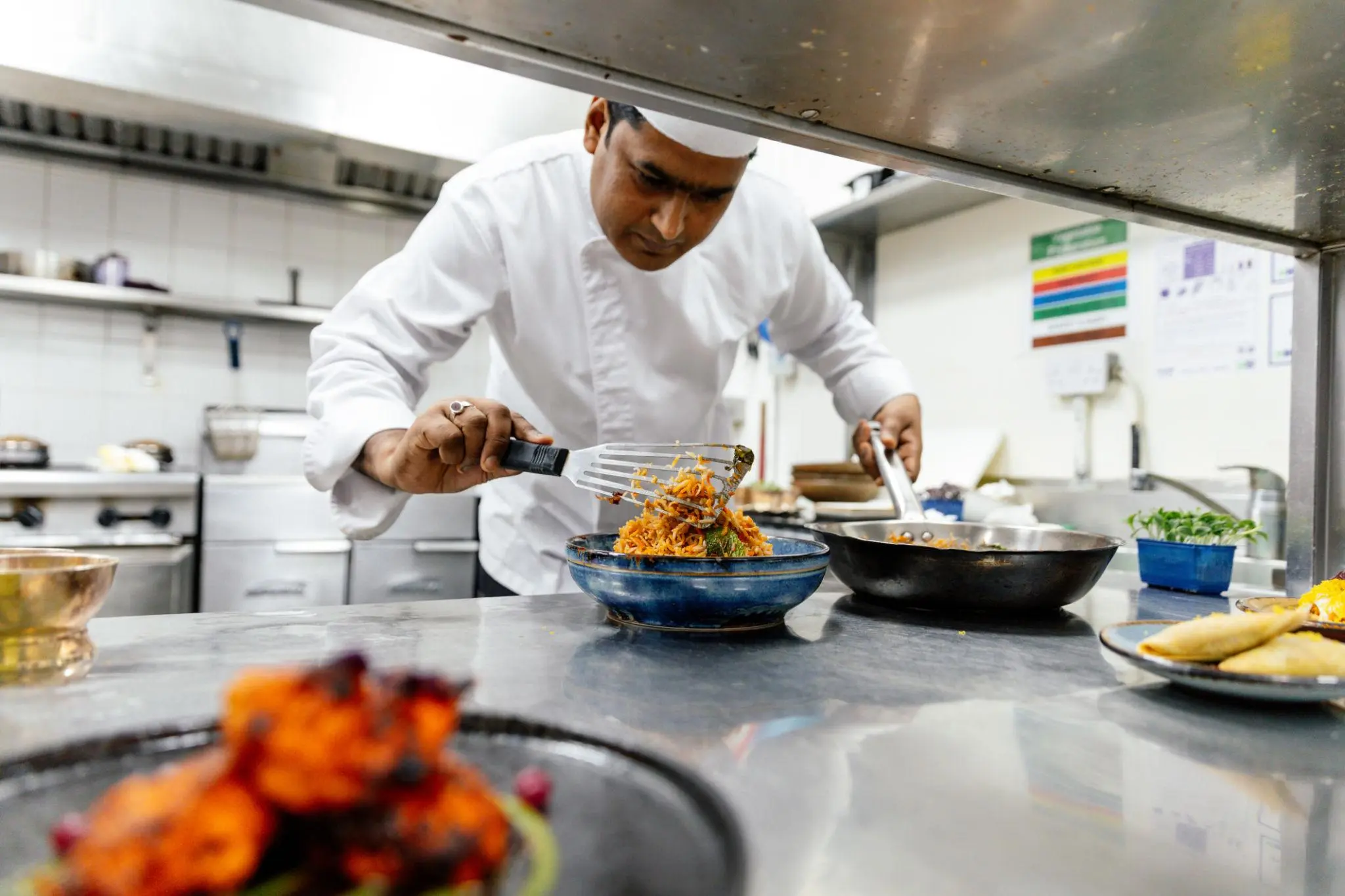 Chef preparing authentic Indian cuisine at Jai Indian Kitchen